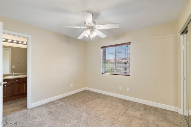 9305 Ironsend St, Las Vegas, NV 89143 - unfurnished bedroom with light colored carpet, connected bathroom, a closet, and a ceiling fan
