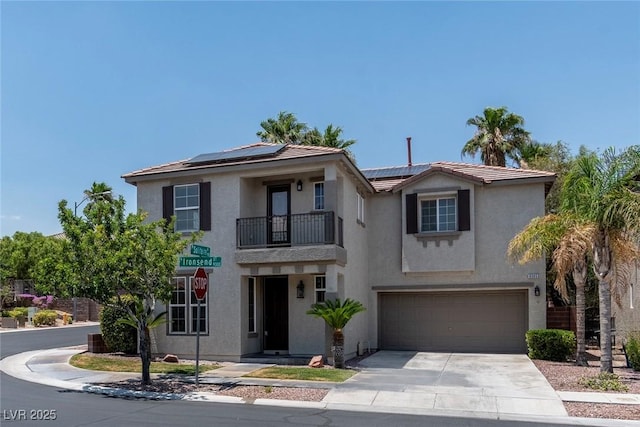 9305 Ironsend St, Las Vegas, NV 89143 - view of front of house with a balcony, a garage, concrete driveway, and roof mounted solar panels