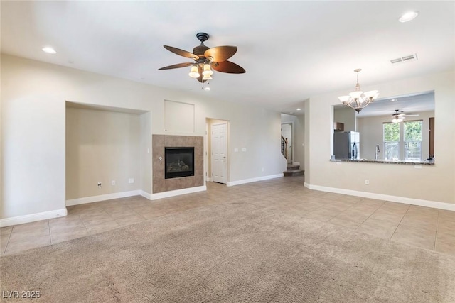 9305 Ironsend St, Las Vegas, NV 89143 - unfurnished living room featuring a ceiling fan, light tile patterned flooring, a chandelier, recessed lighting, and a tile fireplace