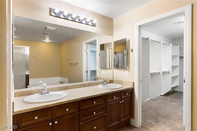 9305 Ironsend St, Las Vegas, NV 89143 - full bathroom with double vanity, a spacious closet, and a garden tub