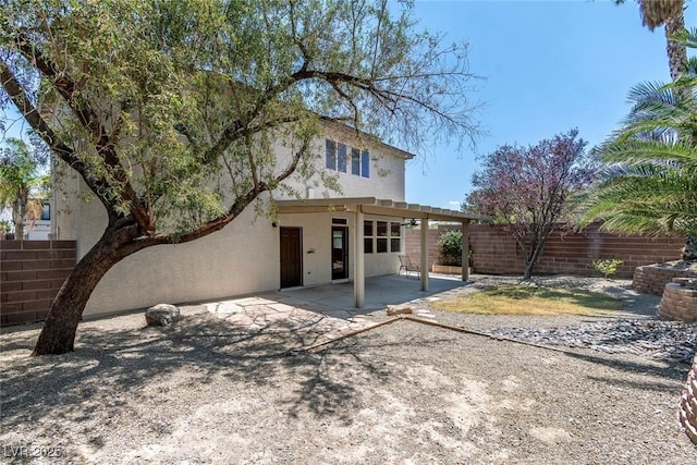 9305 Ironsend St, Las Vegas, NV 89143 - rear view of property featuring stucco siding, a fenced backyard, and a patio area