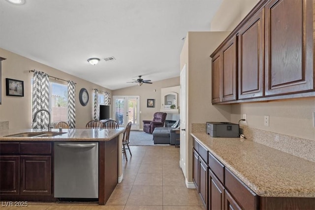 4928 Corsica Island St, North Las Vegas, NV 89031 - kitchen featuring dishwasher, a ceiling fan, lofted ceiling, light tile patterned floors, and open floor plan