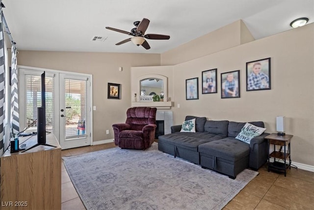 4928 Corsica Island St, North Las Vegas, NV 89031 - living room featuring light tile patterned floors, lofted ceiling, and a ceiling fan