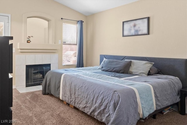 4928 Corsica Island St, North Las Vegas, NV 89031 - bedroom featuring carpet, vaulted ceiling, and a tile fireplace