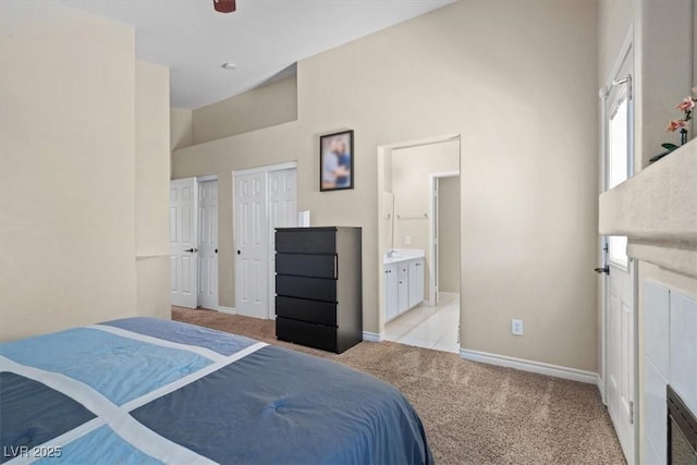 4928 Corsica Island St, North Las Vegas, NV 89031 - bedroom featuring multiple closets, light carpet, ensuite bathroom, high vaulted ceiling, and a ceiling fan