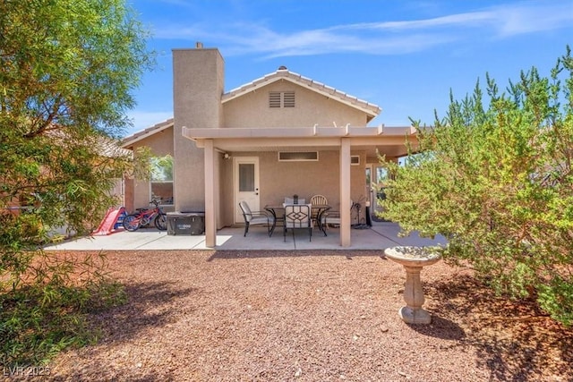 4928 Corsica Island St, North Las Vegas, NV 89031 - back of property featuring a patio, stucco siding, and a chimney