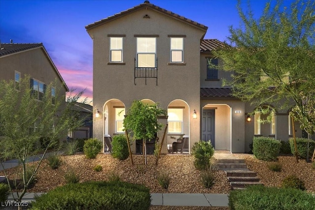 3310 Palindrome Ave, Henderson, NV 89044 - mediterranean / spanish-style house with a tile roof, stucco siding, and covered porch