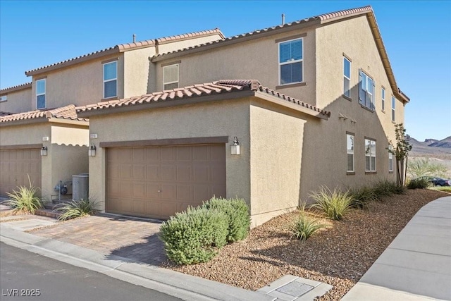 3310 Palindrome Ave, Henderson, NV 89044 - view of front of home featuring stucco siding, an attached garage, driveway, and a tiled roof
