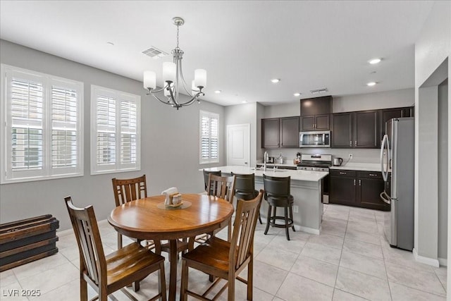 3310 Palindrome Ave, Henderson, NV 89044 - dining room with a chandelier, light tile patterned floors, and recessed lighting