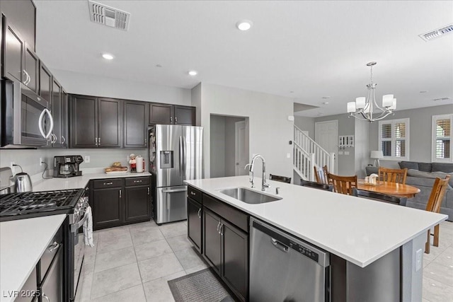 3310 Palindrome Ave, Henderson, NV 89044 - kitchen with appliances with stainless steel finishes, a chandelier, light countertops, pendant lighting, and open floor plan
