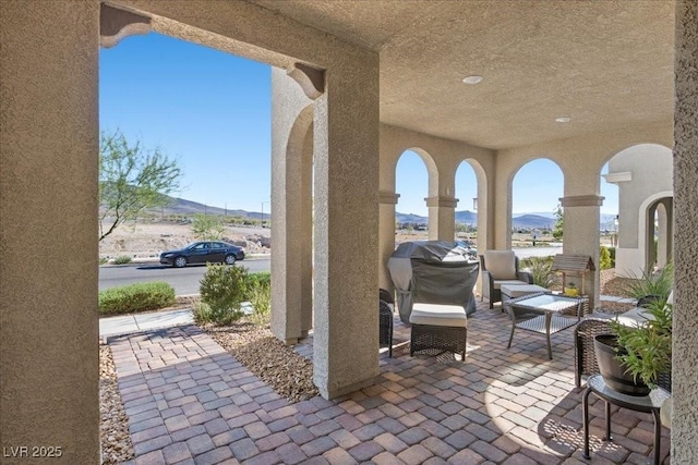 3310 Palindrome Ave, Henderson, NV 89044 - view of patio featuring a mountain view, a grill, and outdoor lounge area