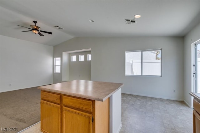 352 River Glider Ave, North Las Vegas, NV 89084 - kitchen featuring open floor plan, plenty of natural light, vaulted ceiling, a ceiling fan, and a center island