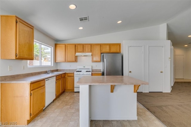 352 River Glider Ave, North Las Vegas, NV 89084 - kitchen with white appliances, under cabinet range hood, a kitchen island, lofted ceiling, and light countertops