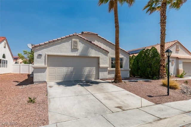 352 River Glider Ave, North Las Vegas, NV 89084 - view of front of house with a tiled roof, driveway, stucco siding, and a garage