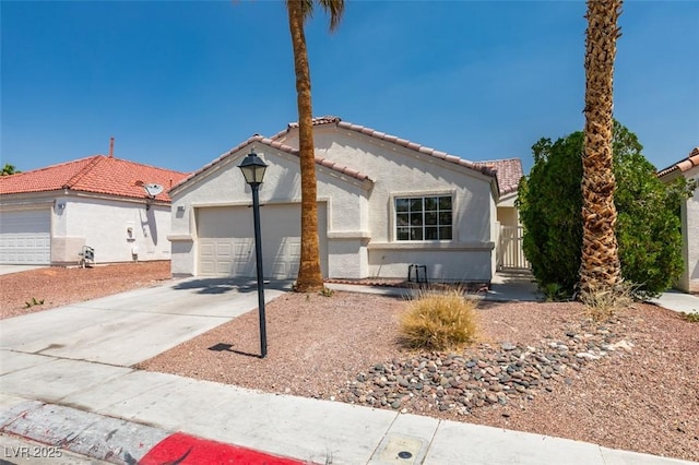 352 River Glider Ave, North Las Vegas, NV 89084 - mediterranean / spanish house featuring a tiled roof, stucco siding, driveway, and a garage