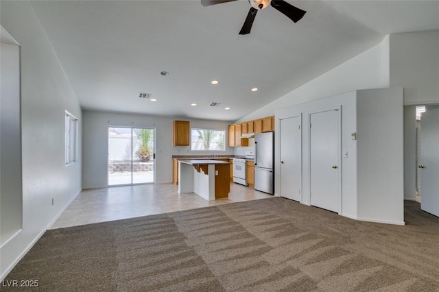 352 River Glider Ave, North Las Vegas, NV 89084 - unfurnished living room featuring recessed lighting, a ceiling fan, lofted ceiling, and light colored carpet