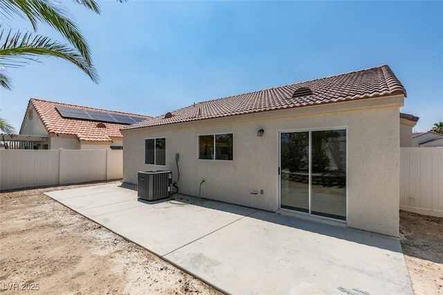 352 River Glider Ave, North Las Vegas, NV 89084 - rear view of house featuring stucco siding, a fenced backyard, a tiled roof, and a patio area