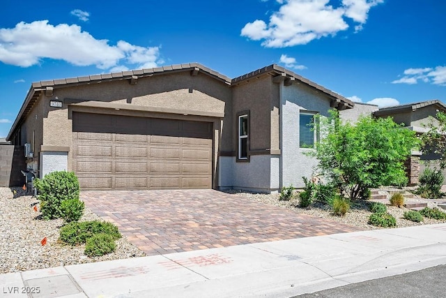 9740 Redwood Cascade St, Las Vegas, NV 89143 - view of front of home with a garage, decorative driveway, and stucco siding