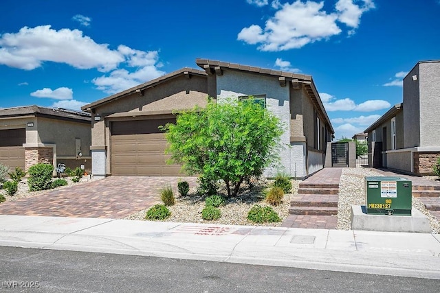 9740 Redwood Cascade St, Las Vegas, NV 89143 - mid-century modern home featuring a garage, decorative driveway, stucco siding, and a gate