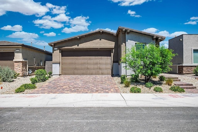 9740 Redwood Cascade St, Las Vegas, NV 89143 - mid-century modern home featuring stucco siding, an attached garage, and decorative driveway