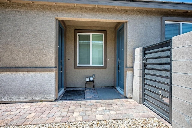 9740 Redwood Cascade St, Las Vegas, NV 89143 - doorway to property with stucco siding
