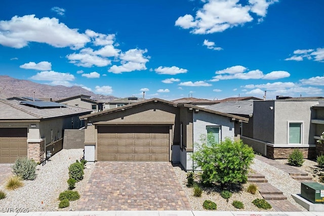 9740 Redwood Cascade St, Las Vegas, NV 89143 - view of front of property featuring stucco siding, an attached garage, decorative driveway, a mountain view, and a tile roof