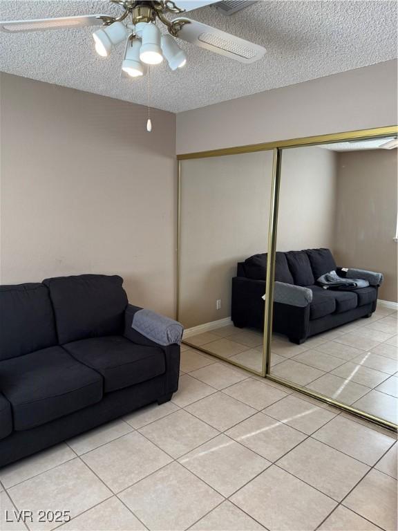 4231 Sanderling Cir Unit 267, Las Vegas, NV 89103 - living area with a textured ceiling, ceiling fan, and light tile patterned floors