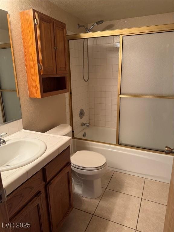 4231 Sanderling Cir Unit 267, Las Vegas, NV 89103 - full bath with vanity, bath / shower combo with glass door, a textured wall, and tile patterned floors