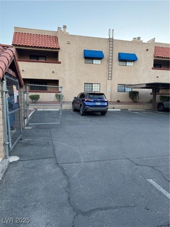 4231 Sanderling Cir Unit 267, Las Vegas, NV 89103 - uncovered parking lot with a gate