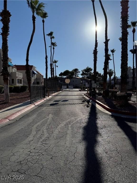 4231 Sanderling Cir Unit 267, Las Vegas, NV 89103 - view of asphalt road with sidewalks, a gate, curbs, and a gated entry