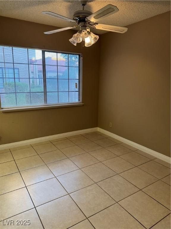 4231 Sanderling Cir Unit 267, Las Vegas, NV 89103 - empty room featuring a textured ceiling, light tile patterned floors, and a ceiling fan