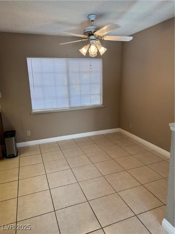 4231 Sanderling Cir Unit 267, Las Vegas, NV 89103 - spare room featuring a textured ceiling, a ceiling fan, and light tile patterned floors