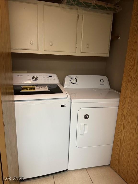 4231 Sanderling Cir Unit 267, Las Vegas, NV 89103 - laundry area with washer and clothes dryer, light tile patterned floors, and cabinet space