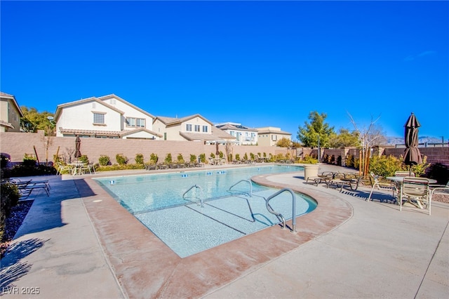 10633 Mount Blackburn Ave, Las Vegas, NV 89166 - community pool with a fenced backyard and a patio area