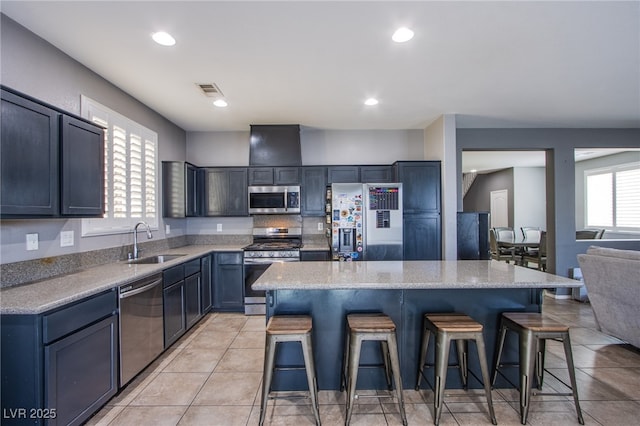 10633 Mount Blackburn Ave, Las Vegas, NV 89166 - kitchen with stainless steel appliances, a breakfast bar, a kitchen island, recessed lighting, and light tile patterned floors