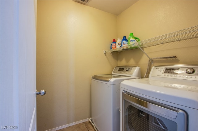 10633 Mount Blackburn Ave, Las Vegas, NV 89166 - washroom with washing machine and clothes dryer and light tile patterned flooring