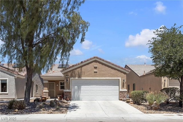 2404 Willow Wren Dr, North Las Vegas, NV 89084 - single story home featuring a garage, driveway, roof mounted solar panels, a tiled roof, and stone siding