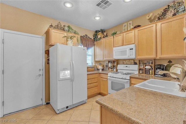 2404 Willow Wren Dr, North Las Vegas, NV 89084 - kitchen with white appliances, light brown cabinets, light countertops, and recessed lighting