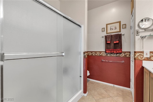 2404 Willow Wren Dr, North Las Vegas, NV 89084 - bathroom with vanity, a shower stall, tile patterned floors, and wainscoting