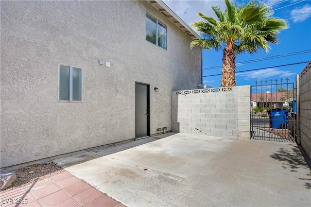 730 Arrowhead Trl, Henderson, NV 89002 - rear view of property with stucco siding, a gate, and a patio