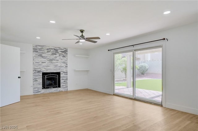 730 Arrowhead Trl, Henderson, NV 89002 - unfurnished living room with a ceiling fan, wood finished floors, recessed lighting, and a tiled fireplace