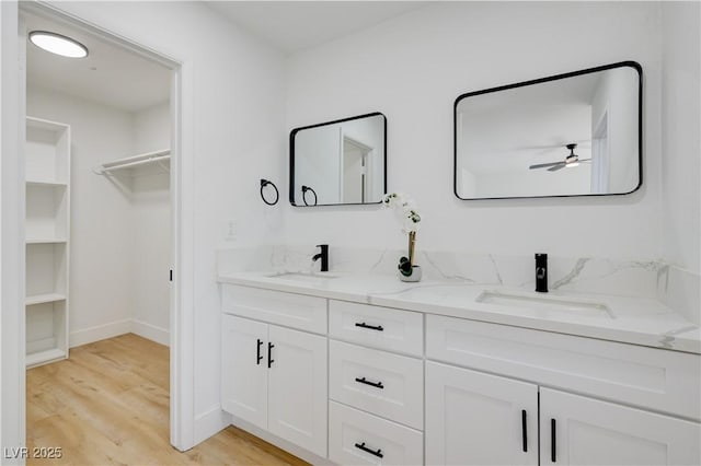 730 Arrowhead Trl, Henderson, NV 89002 - full bathroom featuring double vanity, wood finished floors, ceiling fan, and a walk in closet