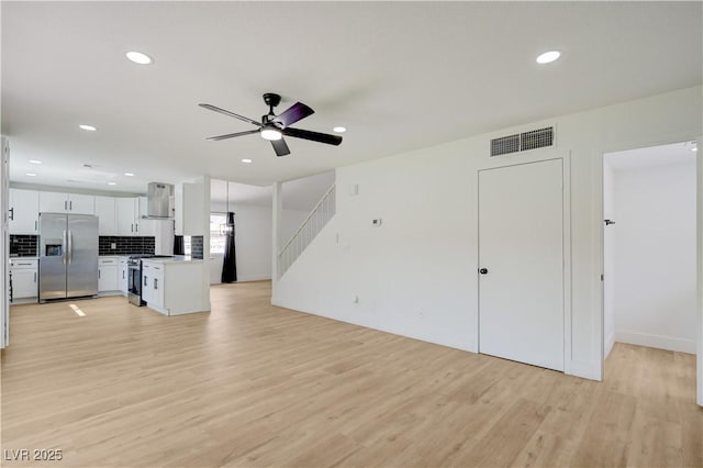 730 Arrowhead Trl, Henderson, NV 89002 - unfurnished living room featuring a ceiling fan, light wood-type flooring, recessed lighting, and stairs