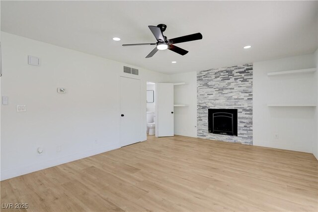 730 Arrowhead Trl, Henderson, NV 89002 - unfurnished living room featuring a ceiling fan, wood finished floors, recessed lighting, and a tile fireplace