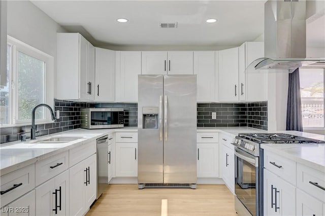 730 Arrowhead Trl, Henderson, NV 89002 - kitchen with appliances with stainless steel finishes, extractor fan, light stone countertops, white cabinetry, and recessed lighting