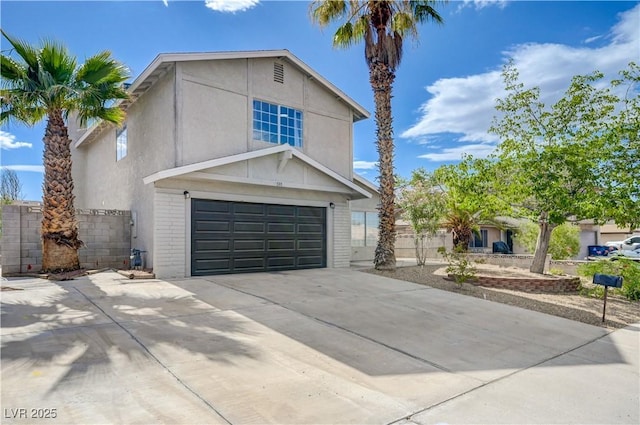 730 Arrowhead Trl, Henderson, NV 89002 - view of front of home with a garage, concrete driveway, brick siding, and stucco siding