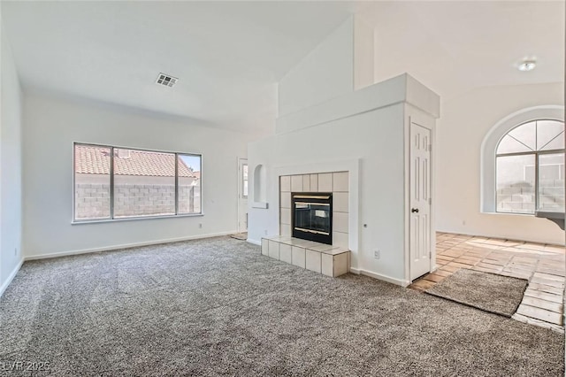 4616 Silversword Ave, North Las Vegas, NV 89032 - unfurnished living room with carpet floors, lofted ceiling, and a fireplace