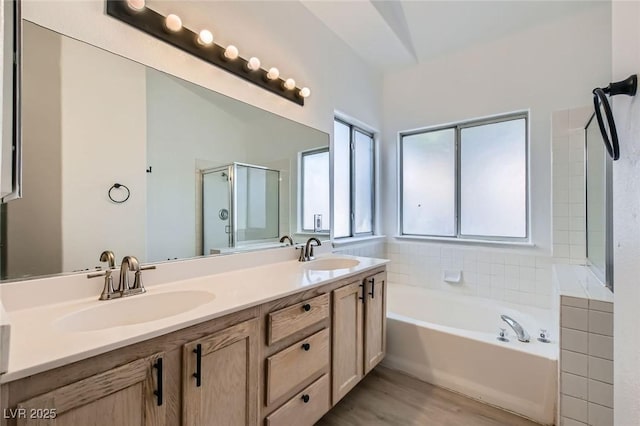 4616 Silversword Ave, North Las Vegas, NV 89032 - bathroom with a shower stall, a garden tub, double vanity, and wood finished floors