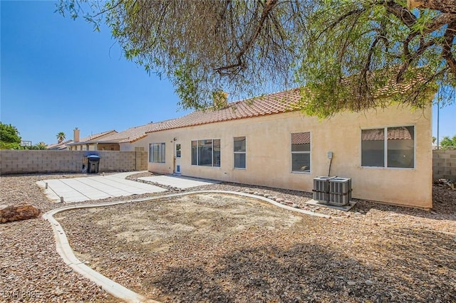 4616 Silversword Ave, North Las Vegas, NV 89032 - rear view of property featuring stucco siding, a fenced backyard, a patio area, and a tiled roof