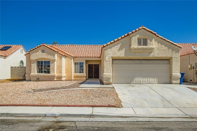 4616 Silversword Ave, North Las Vegas, NV 89032 - mediterranean / spanish-style home featuring stucco siding, a tile roof, concrete driveway, and an attached garage
